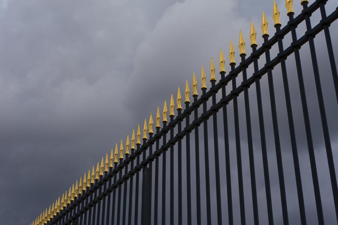 a black aluminum fence gate